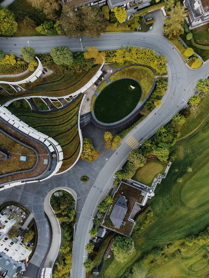Stunning aerial shot showcasing green rooftops and winding roads.